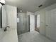 Bright bathroom with a glass shower, white marble floors, and a neutral-toned vanity at 1831 Abbots Hill Dr, Orlando, FL 32835