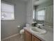 Cozy bathroom with neutral tones, a toilet, sink, and a mirror to provide a functional space at 1831 Abbots Hill Dr, Orlando, FL 32835