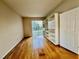 Bedroom with hardwood floors, custom shelving, and a sliding glass door to the backyard at 1831 Abbots Hill Dr, Orlando, FL 32835