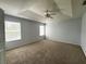 Bedroom featuring textured ceiling, plush carpet, closet, and two windows at 1831 Abbots Hill Dr, Orlando, FL 32835