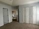 Spacious bedroom with plush carpet, neutral walls, and a large closet at 1831 Abbots Hill Dr, Orlando, FL 32835