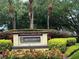 MetroWest entrance sign surrounded by lush landscaping, trees, and colorful flowers at 1831 Abbots Hill Dr, Orlando, FL 32835
