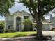 Charming two-story home with landscaped yard and mature trees adding curb appeal at 1831 Abbots Hill Dr, Orlando, FL 32835