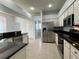 Modern kitchen features stainless steel appliances, white cabinets, and stone countertops at 1831 Abbots Hill Dr, Orlando, FL 32835