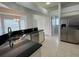 Open kitchen has stainless steel appliances, an eat-in bar, and a view to the breakfast nook at 1831 Abbots Hill Dr, Orlando, FL 32835