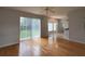 Bright living room with hardwood floors, sliding glass door to the backyard, and a ceiling fan at 1831 Abbots Hill Dr, Orlando, FL 32835