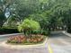Landscaped street corner with flowers and mature trees create a beautiful entrance at 1831 Abbots Hill Dr, Orlando, FL 32835