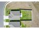 Aerial shot showcasing a well-manicured backyard with patio furniture, lush lawn, and privacy fence at 1963 Thompson Preserve Blvd, Bartow, FL 33830