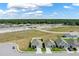 Aerial view of new homes, showcasing well-maintained lawns, neighborhood layout and surrounding landscape at 1963 Thompson Preserve Blvd, Bartow, FL 33830