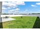 Large backyard featuring a patio area with seating, and a lush green lawn and white privacy fence at 1963 Thompson Preserve Blvd, Bartow, FL 33830