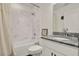 Bright bathroom with white marble tile, granite counters, a bathtub and shower with a white shower curtain at 1963 Thompson Preserve Blvd, Bartow, FL 33830