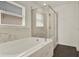 Bathroom featuring a soaking tub with marble surround and a clear glass shower in a bright and airy space at 1963 Thompson Preserve Blvd, Bartow, FL 33830
