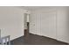 Bright bedroom featuring modern wood-look floors, closet space, neutral paint and a view to living area beyond at 1963 Thompson Preserve Blvd, Bartow, FL 33830