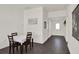 Dining area with a view of the entryway, wood-look floors, and neutral walls giving an inviting atmosphere at 1963 Thompson Preserve Blvd, Bartow, FL 33830
