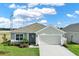 Charming single-story home with a well-manicured lawn, two car garage and beautifully landscaped front yard at 1963 Thompson Preserve Blvd, Bartow, FL 33830