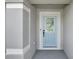 Close-up of the front door of a home, showcasing its light blue color, paneled design, and white trim at 1963 Thompson Preserve Blvd, Bartow, FL 33830