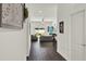 Bright hallway with modern dark wood floors leading to a living area with natural light from the sliding glass door at 1963 Thompson Preserve Blvd, Bartow, FL 33830