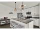 Modern kitchen with stainless steel appliances, gray granite countertops, a kitchen island and pendant lighting at 1963 Thompson Preserve Blvd, Bartow, FL 33830