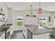 Modern kitchen featuring stainless steel appliances, gray granite countertops, white cabinets, and a kitchen island with seating at 1963 Thompson Preserve Blvd, Bartow, FL 33830
