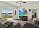 Relaxing living room featuring wood floors, a ceiling fan, an entertainment center, and sliding glass doors to the yard at 1963 Thompson Preserve Blvd, Bartow, FL 33830