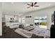 The open-concept design connects the living area with a bright kitchen, perfect for seamless entertaining and modern living at 1963 Thompson Preserve Blvd, Bartow, FL 33830