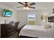This is a bright main bedroom offering a serene atmosphere with the ceiling fan and natural light from the window at 1963 Thompson Preserve Blvd, Bartow, FL 33830