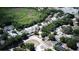 Birds-eye view of a neighborhood with mature trees, well-maintained homes, and a glimpse of a lush green area at 2132 Rouse Lake Rd, Orlando, FL 32817