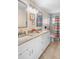 Bathroom features double sinks, a granite countertop, and a shower with multi-colored curtain at 2132 Rouse Lake Rd, Orlando, FL 32817