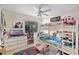 Fun bedroom featuring a bunk bed, dresser, tv, and an alphabet rug at 2132 Rouse Lake Rd, Orlando, FL 32817