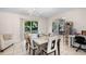 A dining room with seating for six, adjacent to kitchen and living areas at 2132 Rouse Lake Rd, Orlando, FL 32817