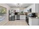 Bright kitchen features stainless appliances, granite counters, and white cabinets at 2132 Rouse Lake Rd, Orlando, FL 32817