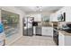 Modern kitchen with white cabinets, stainless steel appliances, and granite countertops at 2132 Rouse Lake Rd, Orlando, FL 32817