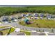 Aerial view of neighborhood featuring green common area with playground in a well-maintained community at 236 Pink Ibis Bnd, St Cloud, FL 34772