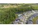 Aerial view of the community pool, playground, and homes near a wooded area at 236 Pink Ibis Bnd, St Cloud, FL 34772