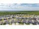 Neighborhood aerial view of home featuring manicured lawns, playground, and surrounding wooded area at 236 Pink Ibis Bnd, St Cloud, FL 34772