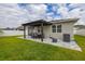 Serene backyard with a paved patio, overhead pergola, and lush green lawn for a perfect outdoor retreat at 236 Pink Ibis Bnd, St Cloud, FL 34772