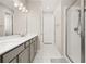 Bathroom featuring double sinks, granite countertops, and a glass door shower at 236 Pink Ibis Bnd, St Cloud, FL 34772