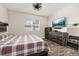 This bedroom features wood floors, a TV, a dresser, and a large window at 236 Pink Ibis Bnd, St Cloud, FL 34772