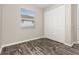 Bedroom with wood-look flooring, closet and large window at 236 Pink Ibis Bnd, St Cloud, FL 34772