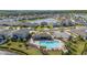 Aerial shot of a neighborhood showing single-Gathering homes, a pool, and a lake with a fountain at 236 Pink Ibis Bnd, St Cloud, FL 34772