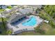 Aerial view of a community pool with lounge chairs and covered seating area at 236 Pink Ibis Bnd, St Cloud, FL 34772