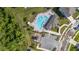Aerial view of the community pool, parking area, and playground with landscaping at 236 Pink Ibis Bnd, St Cloud, FL 34772