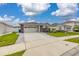 Beautiful single-Gathering home with a spacious driveway, lush lawn, and modern design elements at 236 Pink Ibis Bnd, St Cloud, FL 34772