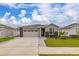 Charming single-story home with a two-car garage, stone accents, and a well-manicured lawn at 236 Pink Ibis Bnd, St Cloud, FL 34772