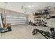 An open garage with hanging racks and overhead garage door system at 236 Pink Ibis Bnd, St Cloud, FL 34772