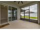 An indoor/outdoor lanai with sliding glass doors and white vinyl fencing at 236 Pink Ibis Bnd, St Cloud, FL 34772