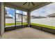 An indoor/outdoor lanai with white vinyl fencing and green grass at 236 Pink Ibis Bnd, St Cloud, FL 34772