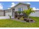 Close-up of vibrant landscaping with palm trees, cacti, and flowering plants adding natural beauty at 236 Pink Ibis Bnd, St Cloud, FL 34772