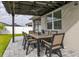 Charming outdoor dining area with a pergola, fan, and seating, perfect for al fresco meals at 236 Pink Ibis Bnd, St Cloud, FL 34772