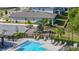 View of the community playground, pool area, and parking lot with lounge chairs at 236 Pink Ibis Bnd, St Cloud, FL 34772